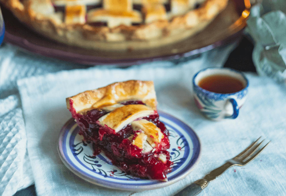 Slice of Cherry Pie sitting on a ceramic plate