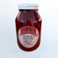 Glass jar of Cherry Pie filling on a white background