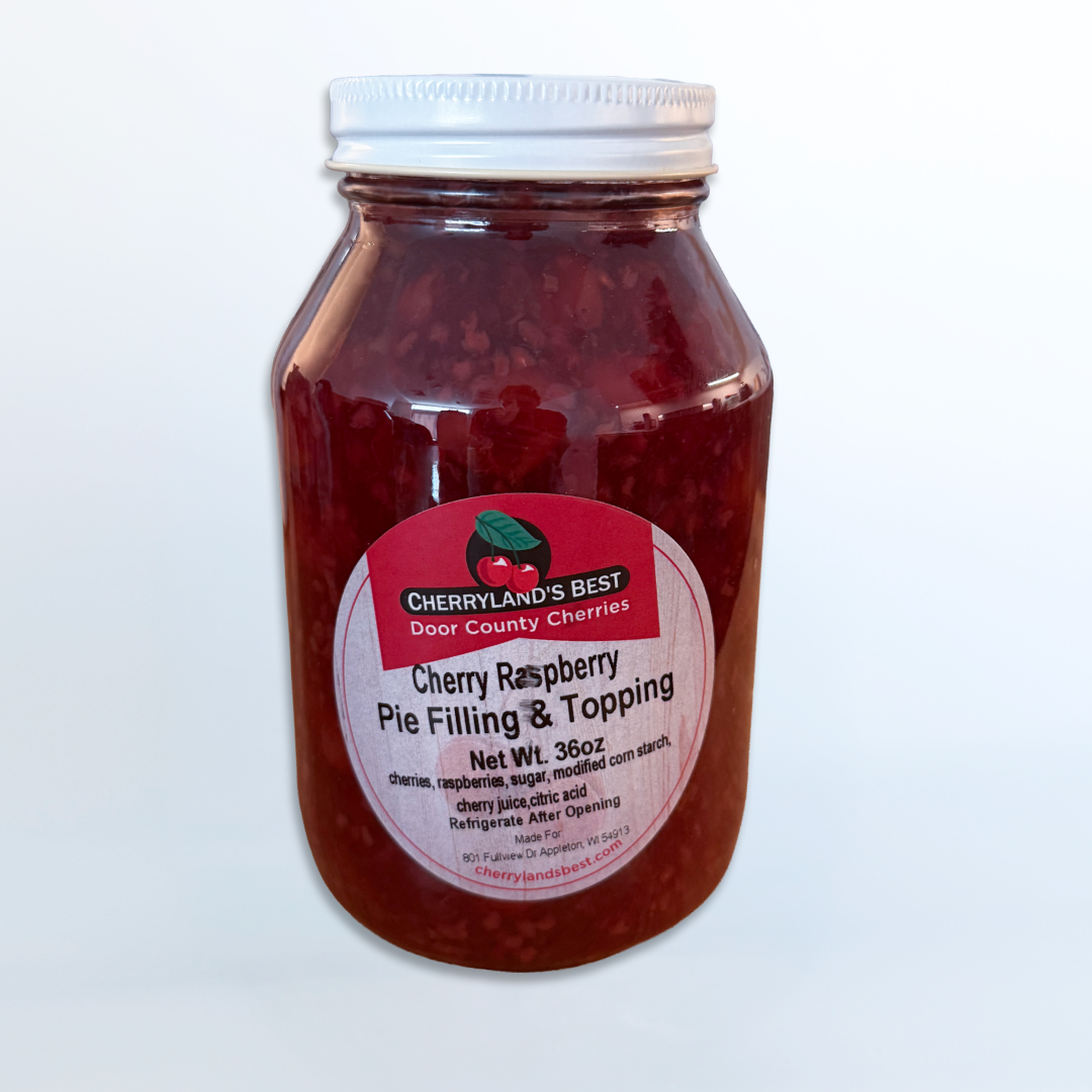 A glass jar of Cherryland's Best Door Country Cherries Cherry Raspberry Pie Filling & Topping with a white lid and a pinkish-red label, set against a plain white background.