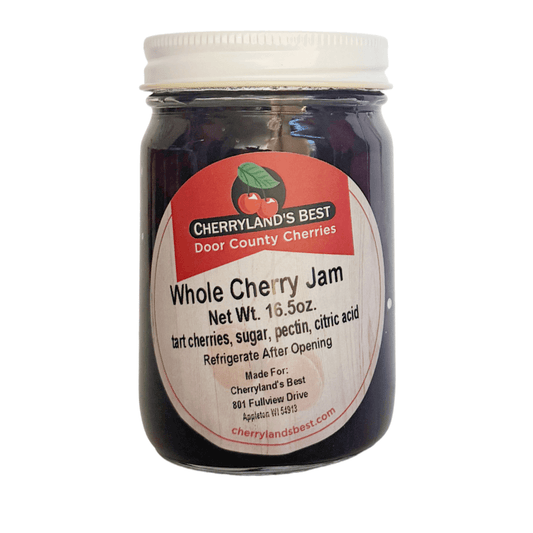 A glass jar of Cherryland's Best Whole Cherry Jam with a white lid and a white label featuring red and black text, set against a plain white background.